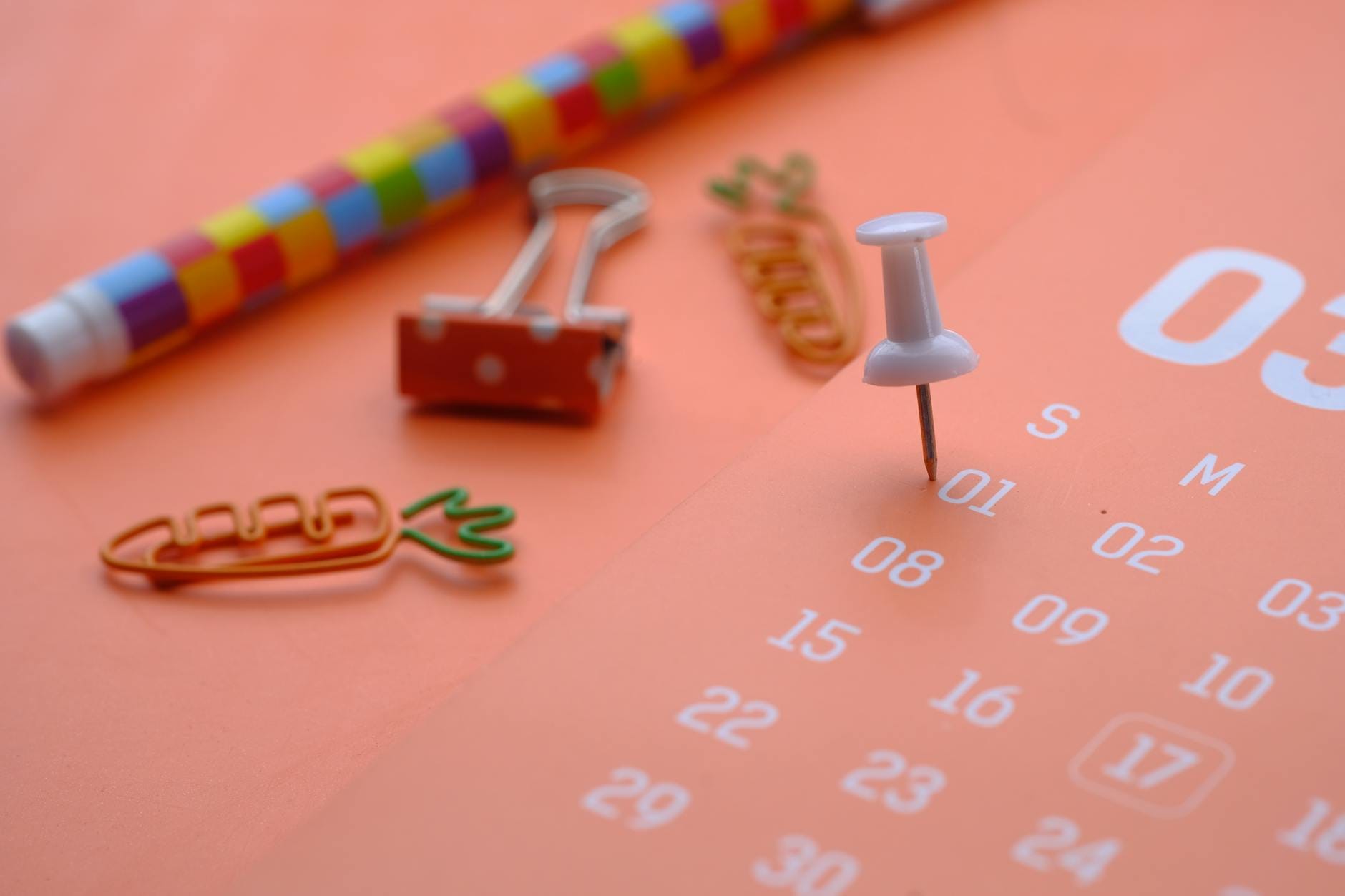 A close-up of colorful office supplies featuring a calendar, perfect for planning and organization themes.