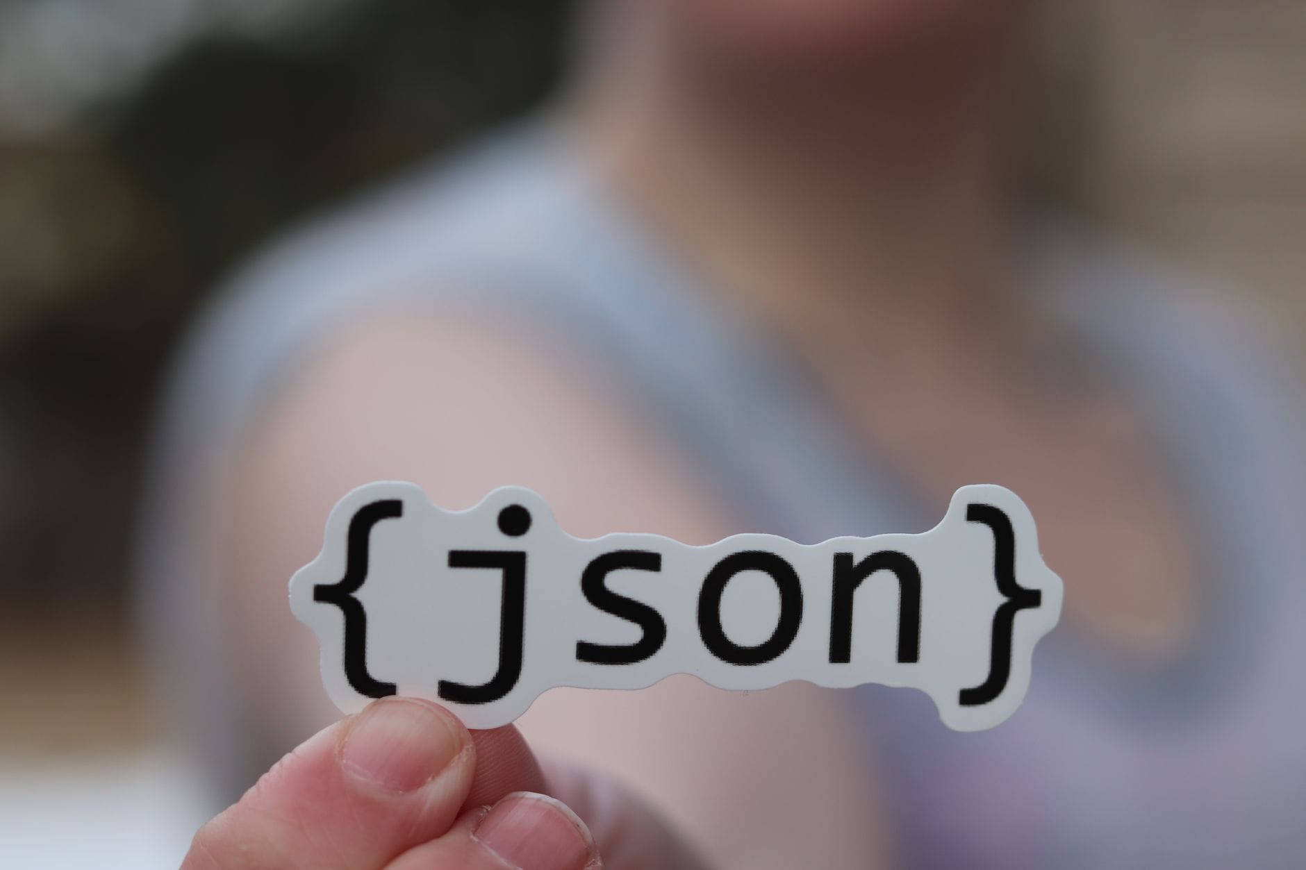 A hand holding a JSON text sticker, symbolic for software development. — brave search mcp server mcp server setup guide