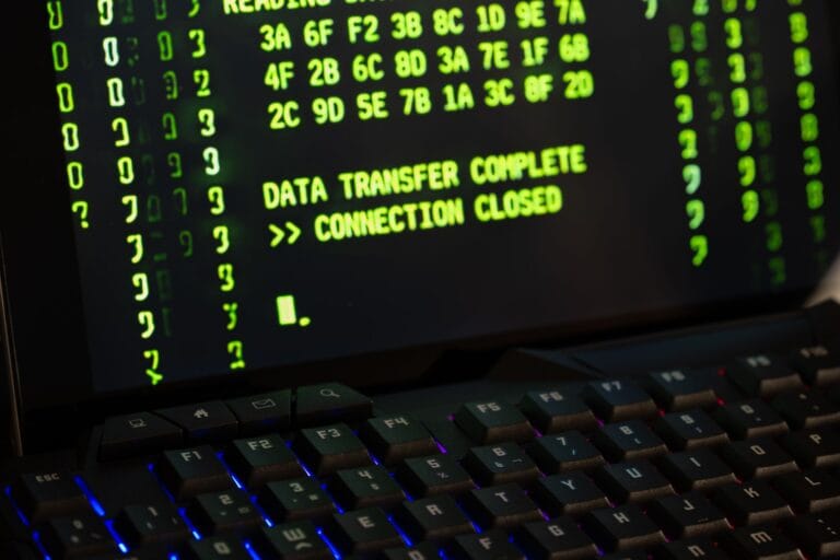 Data transfer complete message displayed on a computer monitor with a keyboard underneath. — openai cybersecurity model