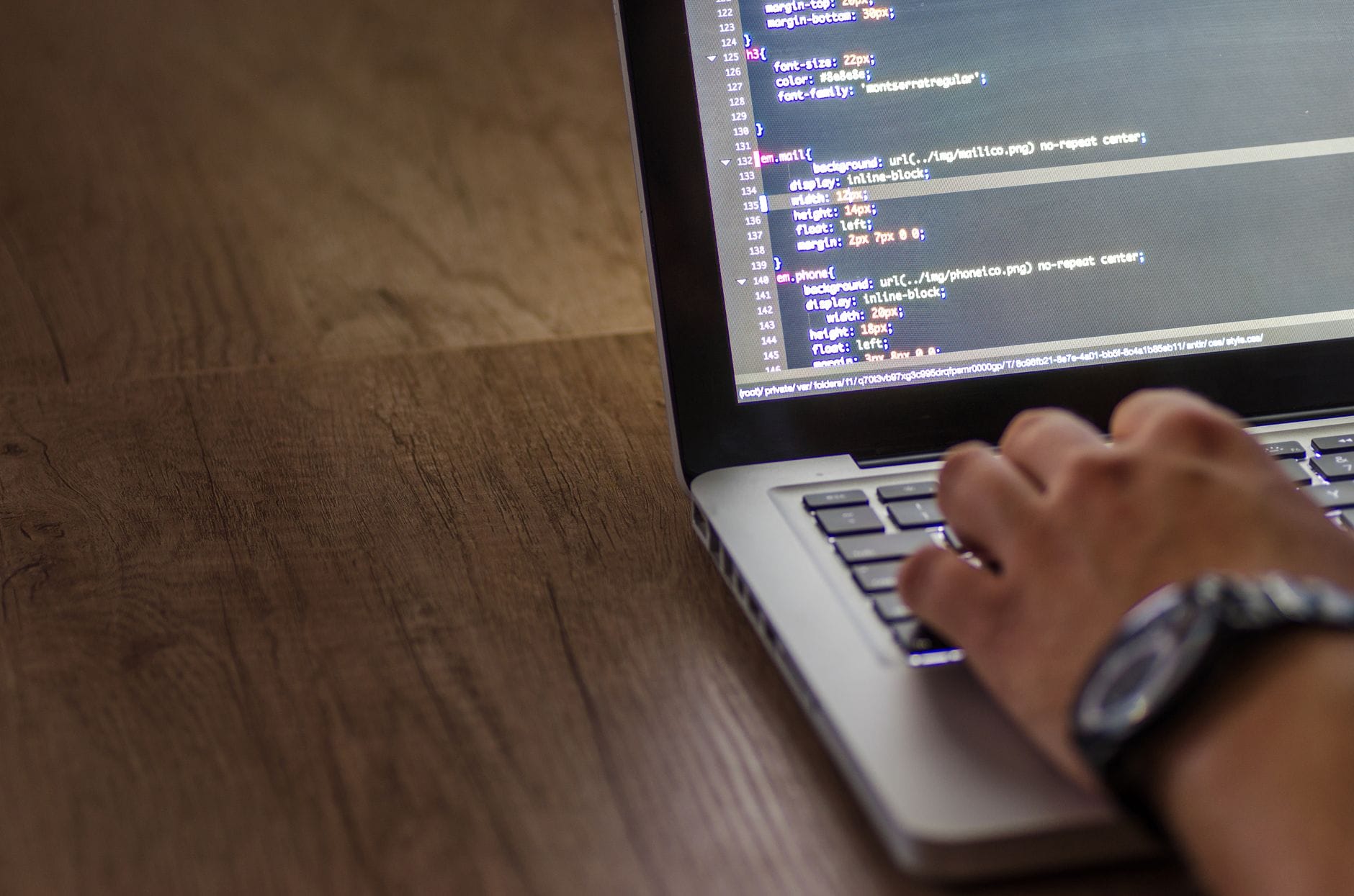A person is typing code on a laptop, focusing on the screen with programming script. — sqlite mcp server mcp server setu