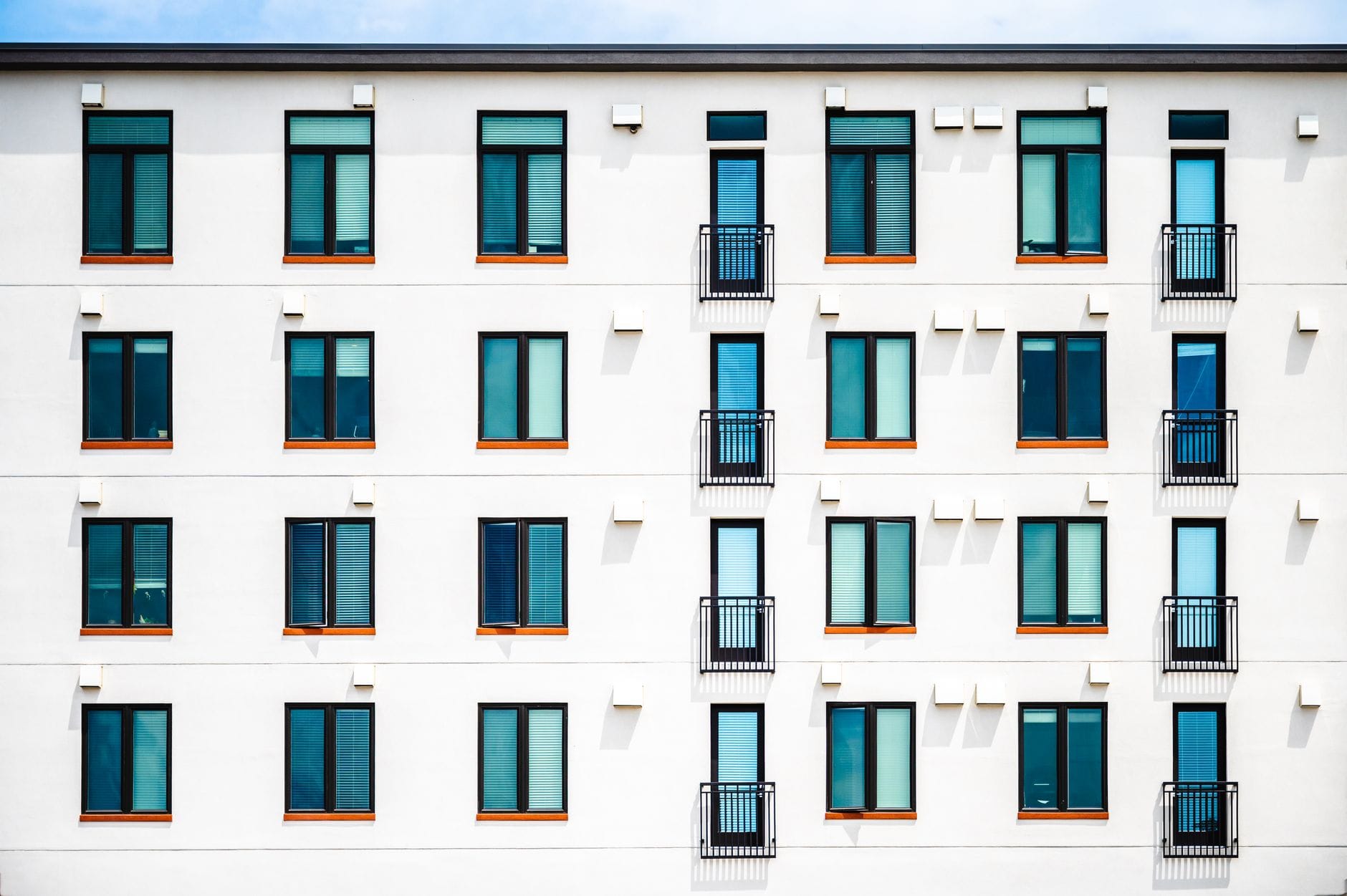 Facade of new white apartment building of simple minimalist style on clear day — forbes ai 50 list 2026 top companies
