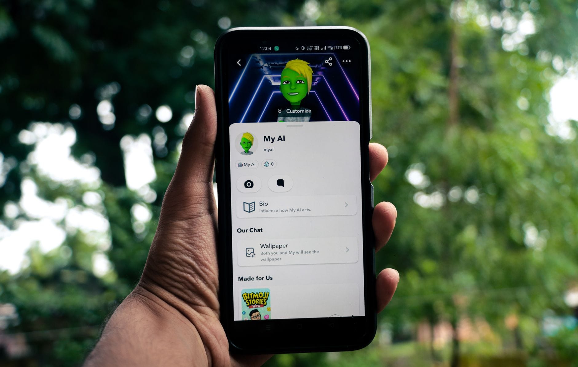 A person holds a smartphone displaying an AI application in a green outdoor setting. — anthropic claude app store number