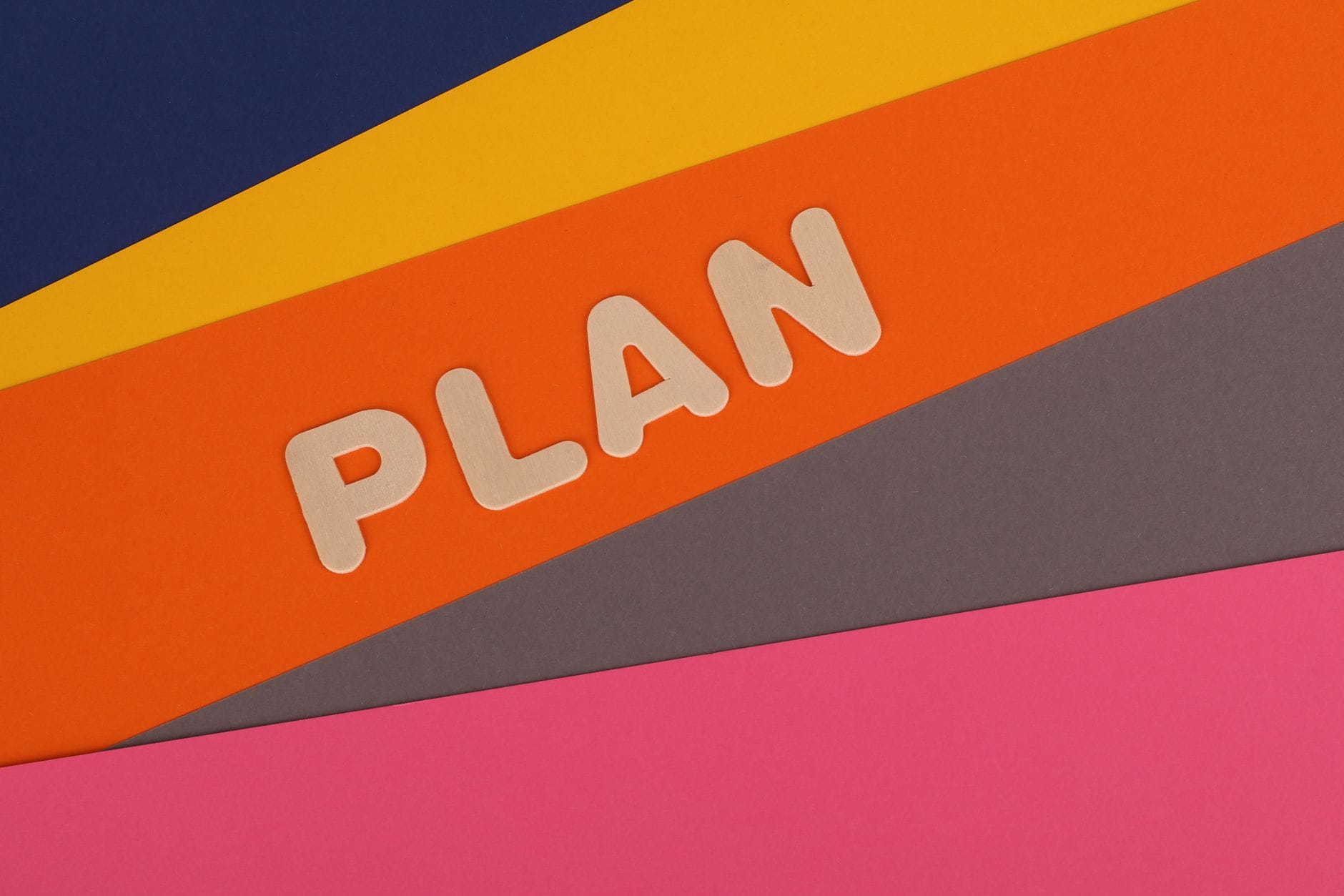 Vibrant geometric colored background with the word 'Plan' in bold letters, perfect for business concepts. — windsurf rev